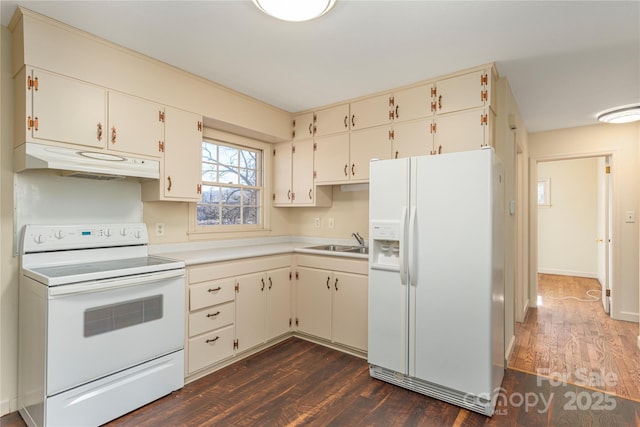 kitchen with white appliances, dark wood-type flooring, a sink, and under cabinet range hood