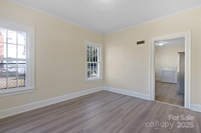 unfurnished bedroom with baseboards, wood finished floors, visible vents, and crown molding