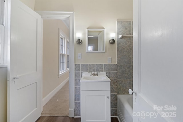 bathroom featuring tile walls and vanity