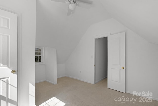 bonus room featuring vaulted ceiling, carpet floors, a ceiling fan, and baseboards