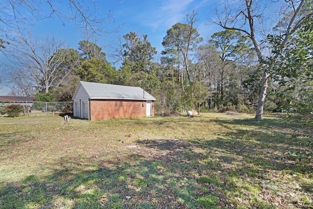 view of yard featuring an outbuilding and fence