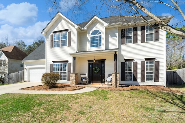 view of front of house with a garage, fence, driveway, and a front lawn