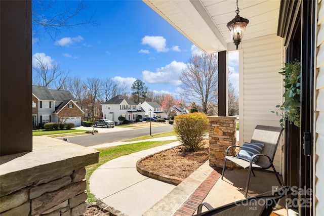 view of patio with a residential view and covered porch