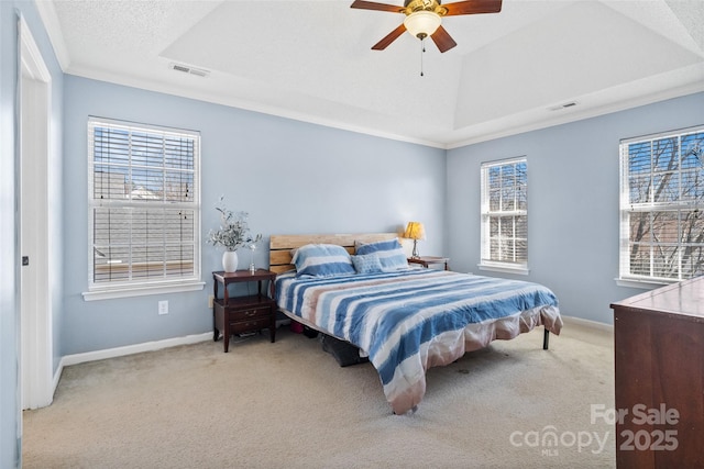 carpeted bedroom featuring a raised ceiling, visible vents, and baseboards