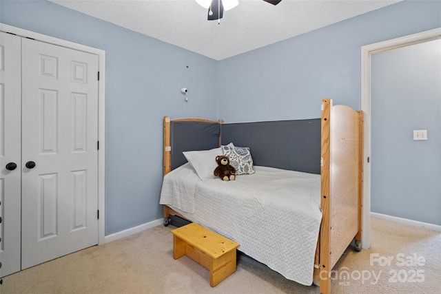 bedroom with ceiling fan, carpet floors, a textured ceiling, and baseboards