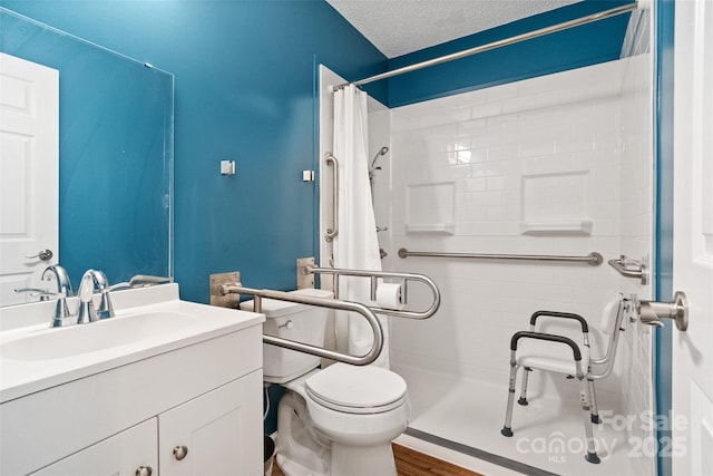 full bath with toilet, a stall shower, a textured ceiling, vanity, and wood finished floors