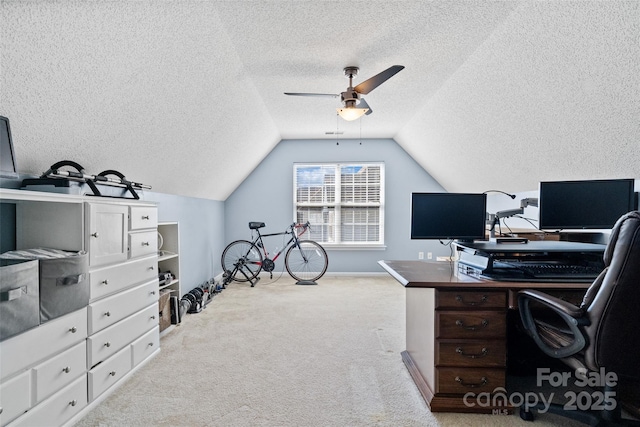 office space with a textured ceiling, carpet flooring, a ceiling fan, baseboards, and vaulted ceiling