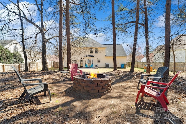 view of yard with a fenced backyard and a fire pit