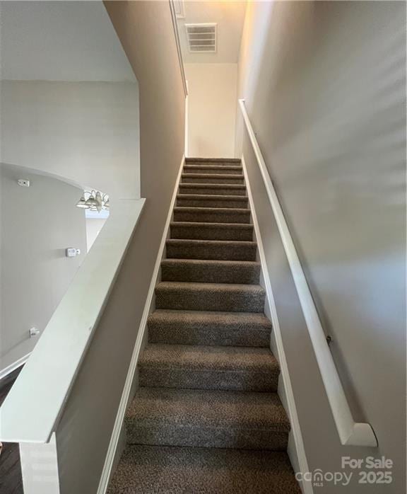 stairs featuring visible vents and baseboards