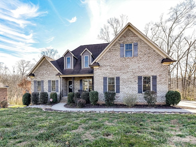 view of front of home with brick siding and a front lawn