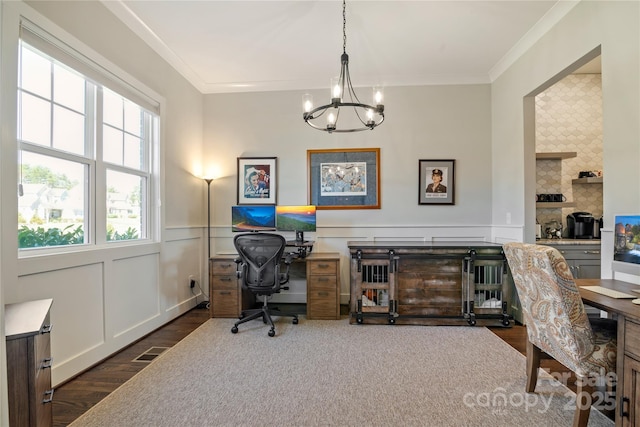 office area featuring a wainscoted wall, a chandelier, wood finished floors, and crown molding