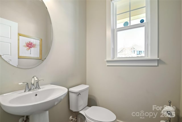 bathroom with toilet and a sink