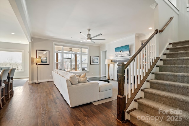 living area with a healthy amount of sunlight, dark wood-style floors, and crown molding