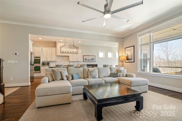 living room featuring dark wood-style floors, ornamental molding, and baseboards