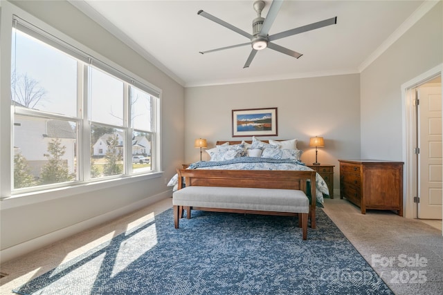 carpeted bedroom with baseboards, ornamental molding, and a ceiling fan