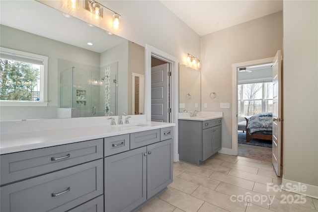 bathroom with a stall shower, tile patterned flooring, and vanity