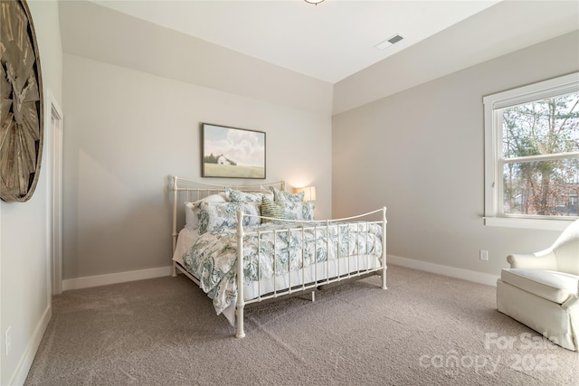 bedroom featuring carpet floors, visible vents, and baseboards