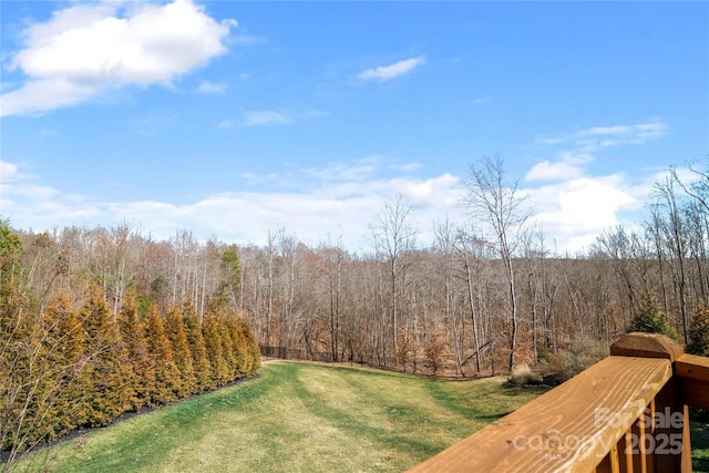 view of yard with a view of trees