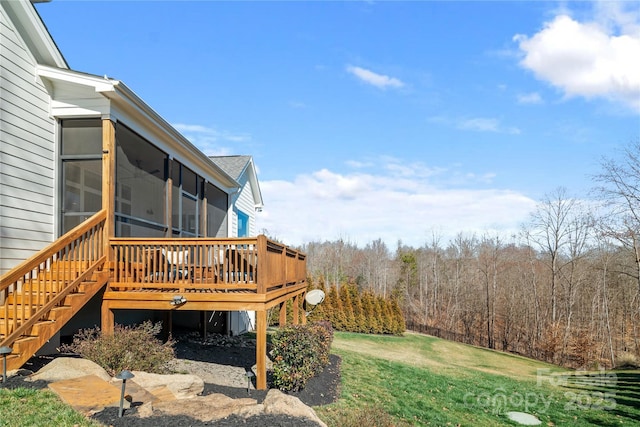 view of yard featuring a sunroom, stairway, and a wooden deck