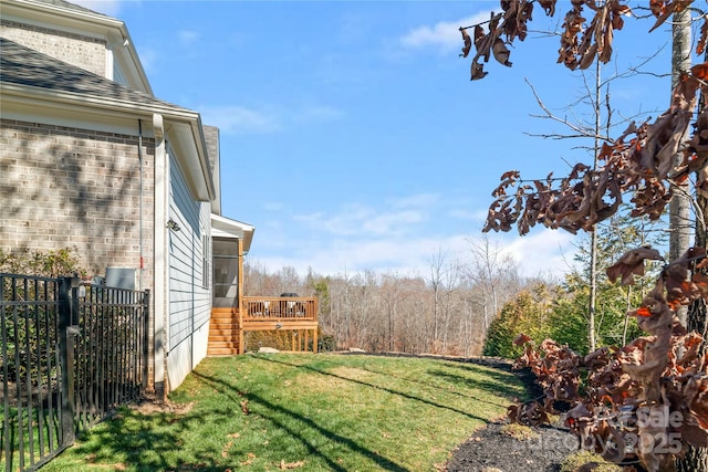 view of yard with a deck and fence