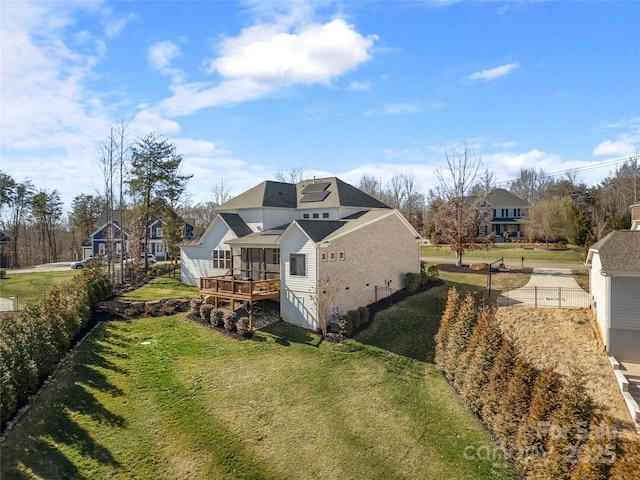 back of property with fence and a lawn