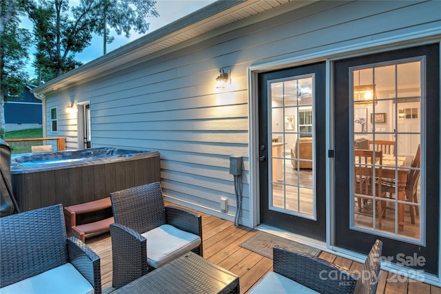 wooden deck with a hot tub