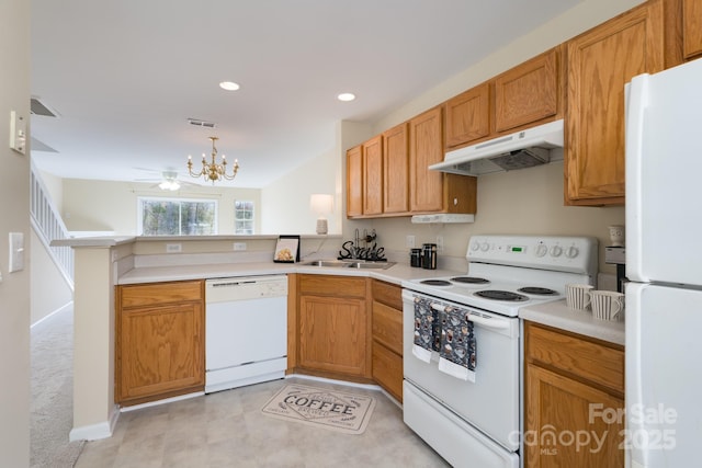 kitchen featuring under cabinet range hood, a peninsula, white appliances, a sink, and light countertops