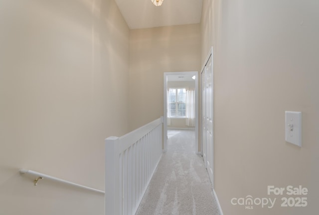 corridor featuring a high ceiling and carpet flooring