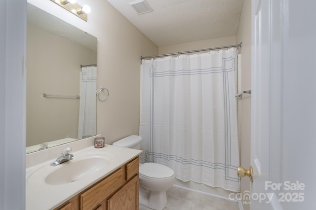 full bathroom featuring toilet, visible vents, a textured ceiling, and vanity