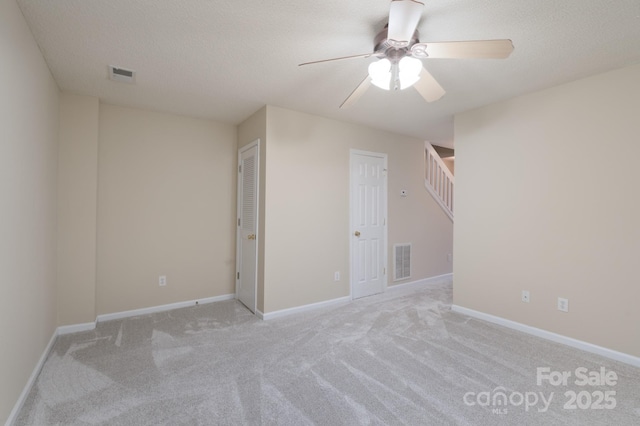 unfurnished room featuring visible vents, ceiling fan, light carpet, and baseboards