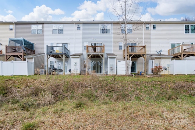 rear view of property with fence