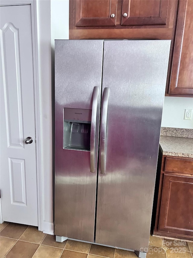 room details with light countertops and stainless steel fridge with ice dispenser