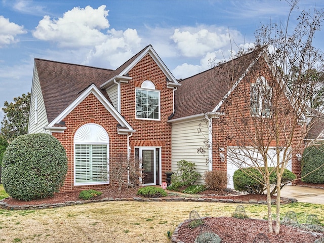 traditional-style home featuring brick siding, a shingled roof, and a front lawn