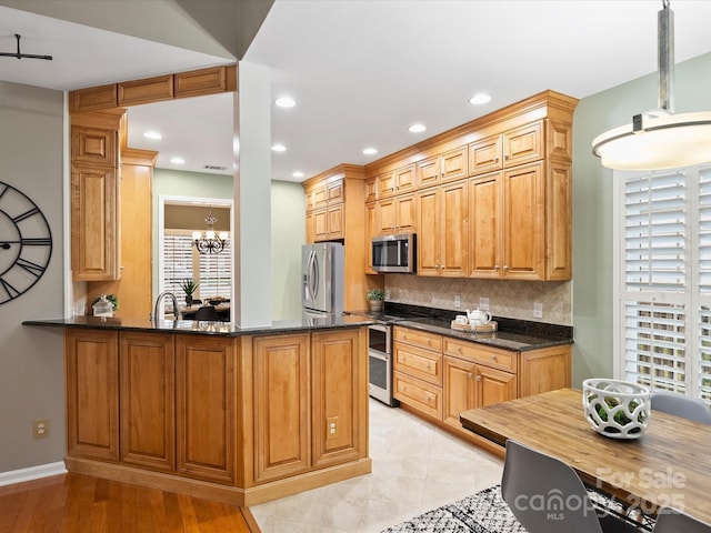 kitchen featuring tasteful backsplash, a notable chandelier, recessed lighting, and stainless steel appliances