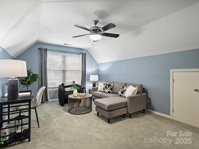 living area with baseboards, lofted ceiling, light colored carpet, and a ceiling fan