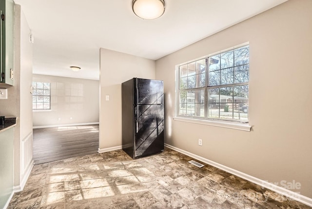 interior space with baseboards and visible vents