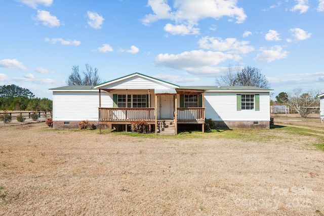 view of front of home featuring crawl space, covered porch, and fence