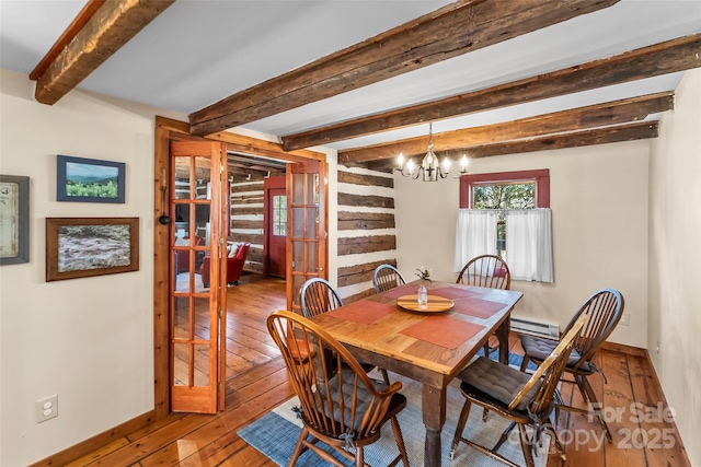 dining room featuring a baseboard heating unit, baseboards, hardwood / wood-style floors, beamed ceiling, and an inviting chandelier