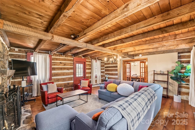 living room with a fireplace, wood ceiling, hardwood / wood-style floors, beamed ceiling, and an inviting chandelier