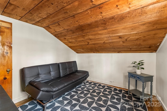 living area with lofted ceiling, wood finished floors, wood ceiling, and baseboards