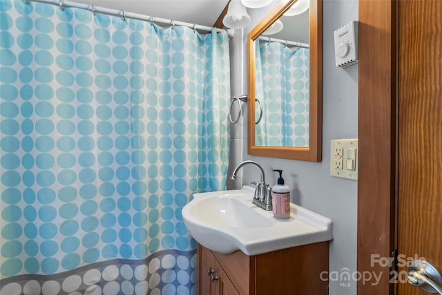 bathroom featuring curtained shower and vanity