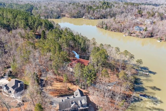 aerial view with a forest view and a water view