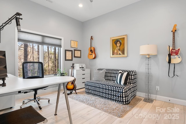 home office featuring light wood finished floors, baseboards, and recessed lighting