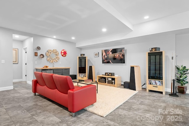 living area featuring baseboards and recessed lighting