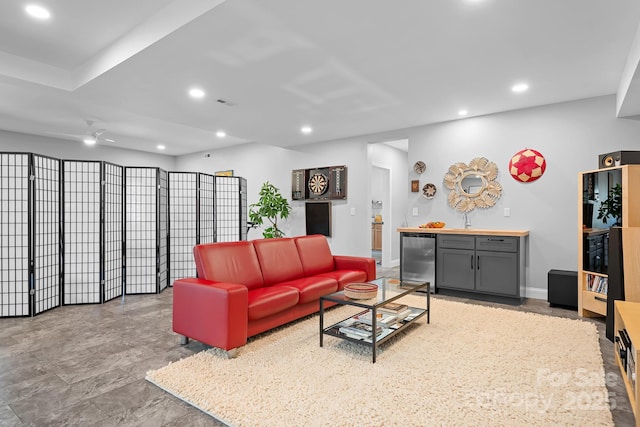 living room with recessed lighting, beverage cooler, ceiling fan, and baseboards