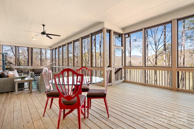 sunroom with a healthy amount of sunlight and ceiling fan