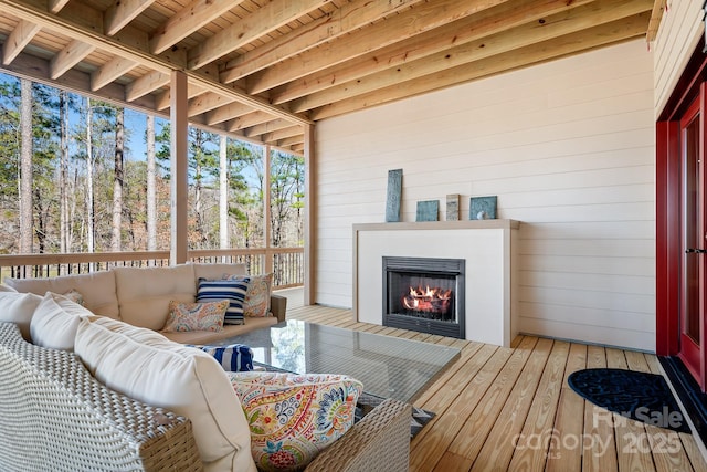 sunroom with a tiled fireplace