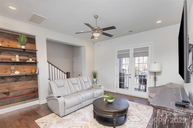 living area with baseboards, visible vents, wood finished floors, and french doors