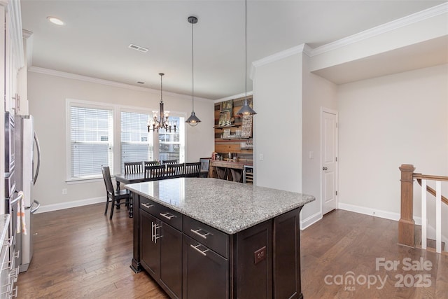 kitchen with baseboards, visible vents, dark wood-style floors, ornamental molding, and dark brown cabinets