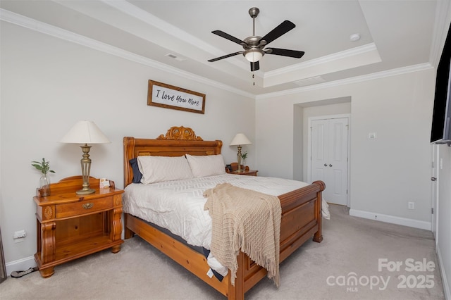 bedroom featuring a raised ceiling, visible vents, ornamental molding, light carpet, and baseboards